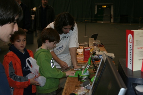 Bryan shows two boys the XO Laptop